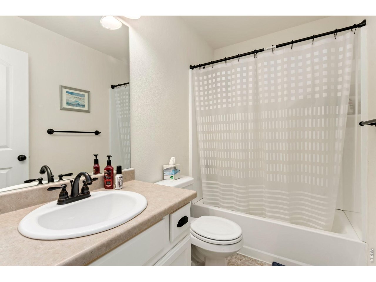 1484 First Light Drive Windsor, CO 80550 - Photo 13 of 23 a bathroom with a sink toilet a mirror and shower