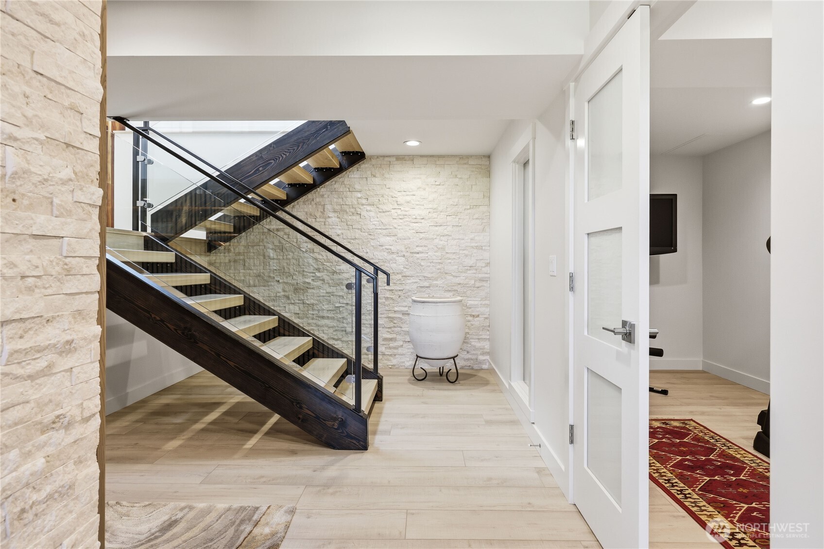 37709 Olympic View Road Northeast Hansville, WA 98340 - Photo 27 of 40 a view of a hallway with wooden floor and staircase
