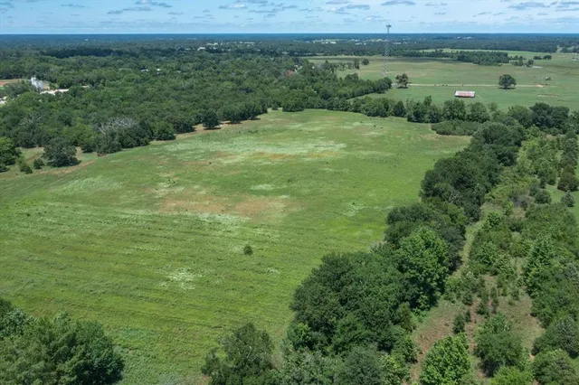 a view of a field with an outdoor space and seating