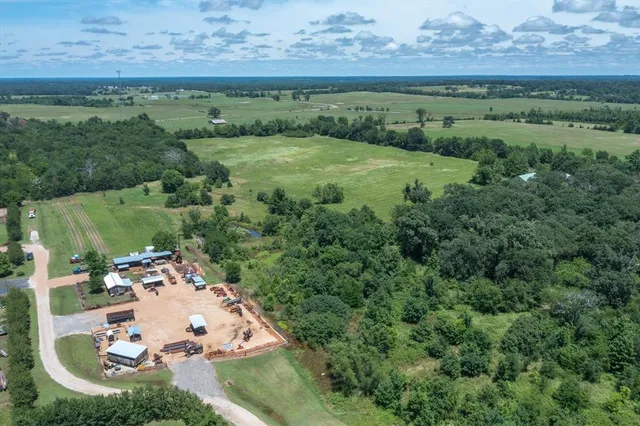 an aerial view of a house with a yard