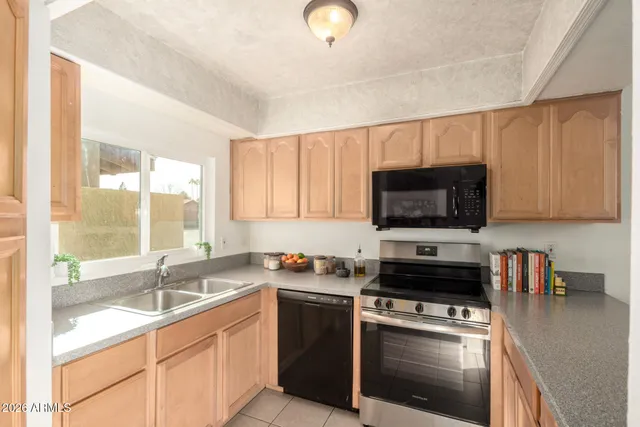 a kitchen with a sink a stove and cabinets
