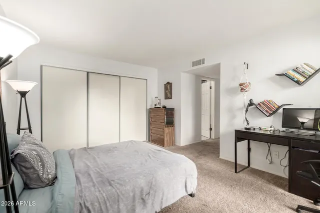 a bedroom with a bed and a desk