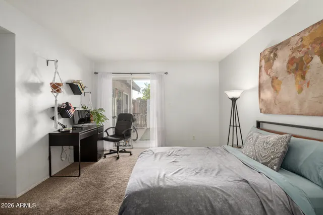 a bedroom that has a bed and a desk in it