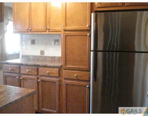 17 Lehigh Road Old Bridge, NJ 08859 - Photo 4 of 10 a kitchen with a refrigerator and cabinets