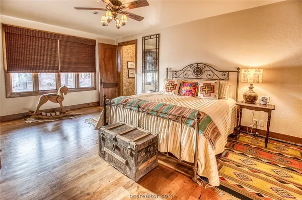 a bedroom with a bed and a large window