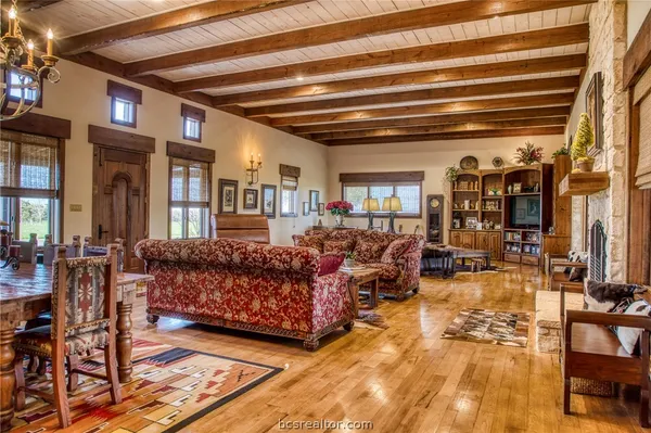 a living room with lots of furniture and a chandelier