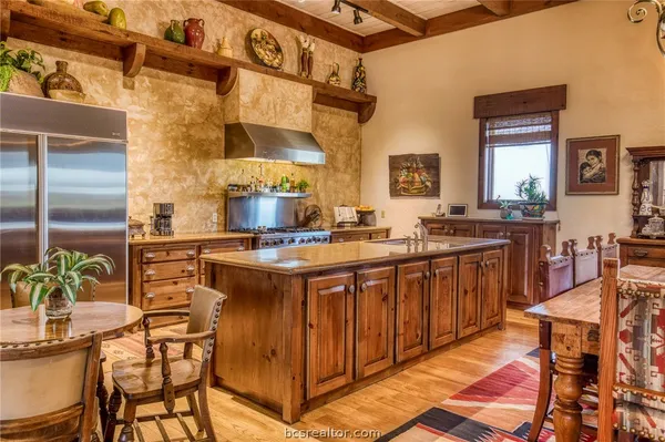 a kitchen with a sink and chairs
