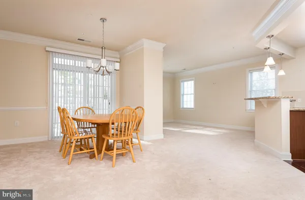 a view of a dining room with furniture and a chandelier