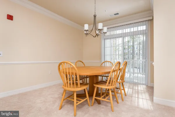 a view of a dining room with furniture window and chandelier
