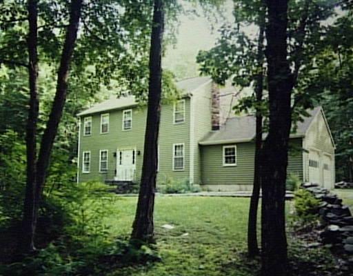 a view of a house with a tree in front of a yard