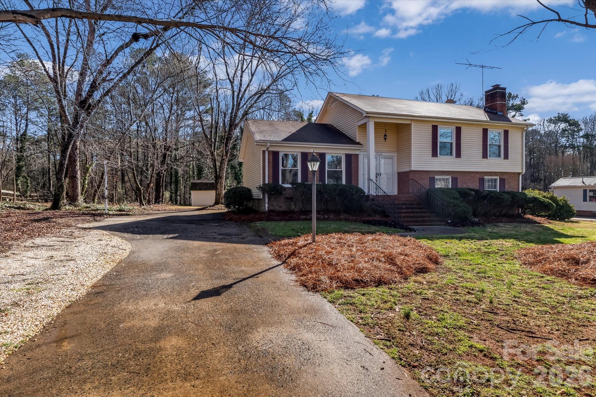 3000 Windrow Lane Matthews, NC 28105 - Photo 3 of 20 a front view of a house with a yard and garage