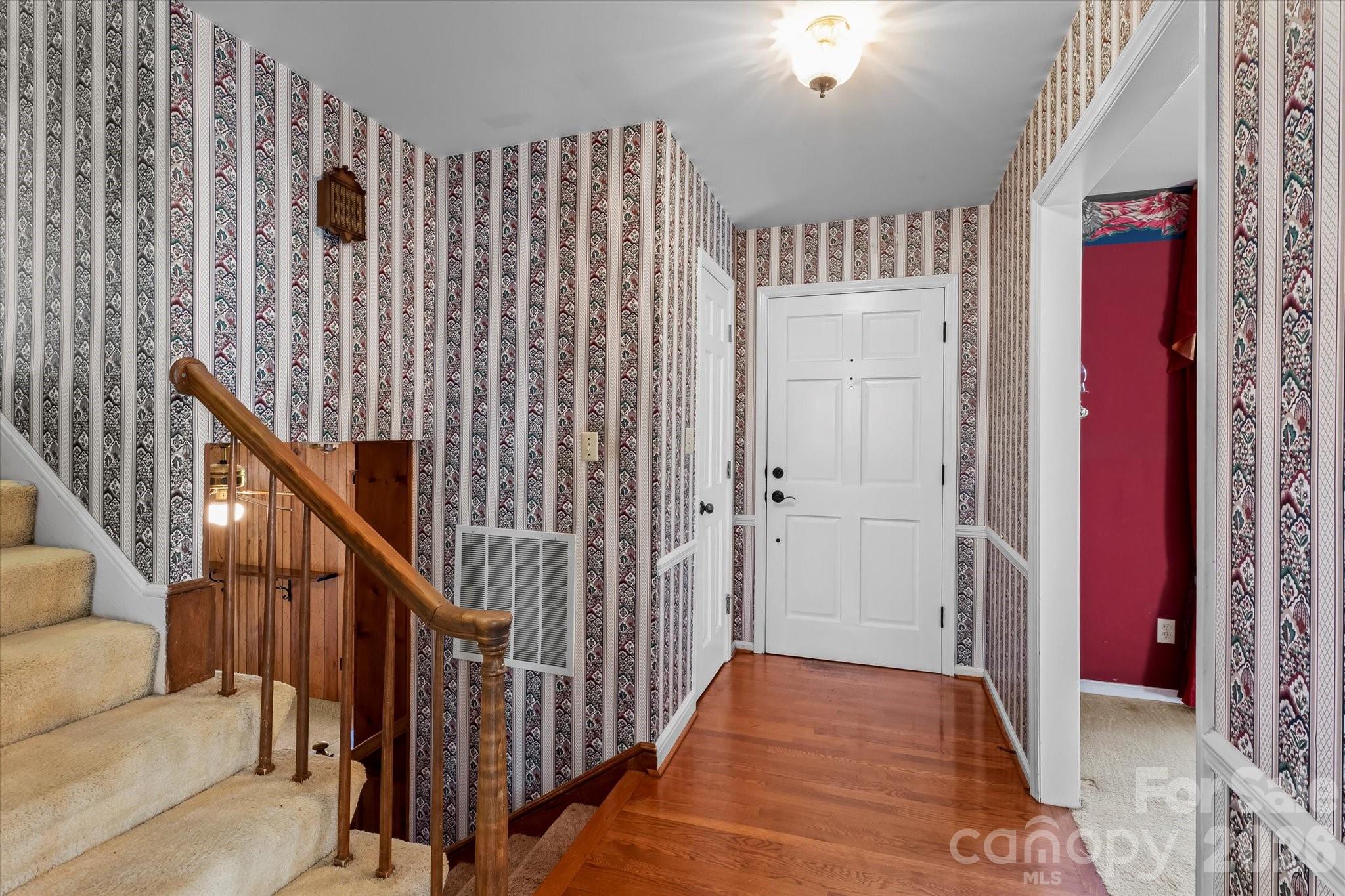3000 Windrow Lane Matthews, NC 28105 - Photo 4 of 20 a view of a hallway with wooden floor and staircase