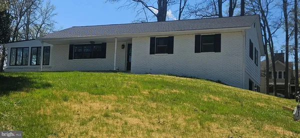 a view of a house with a backyard