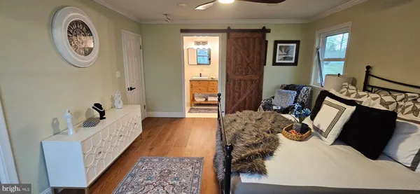 a bed room with a bed mirror and a window