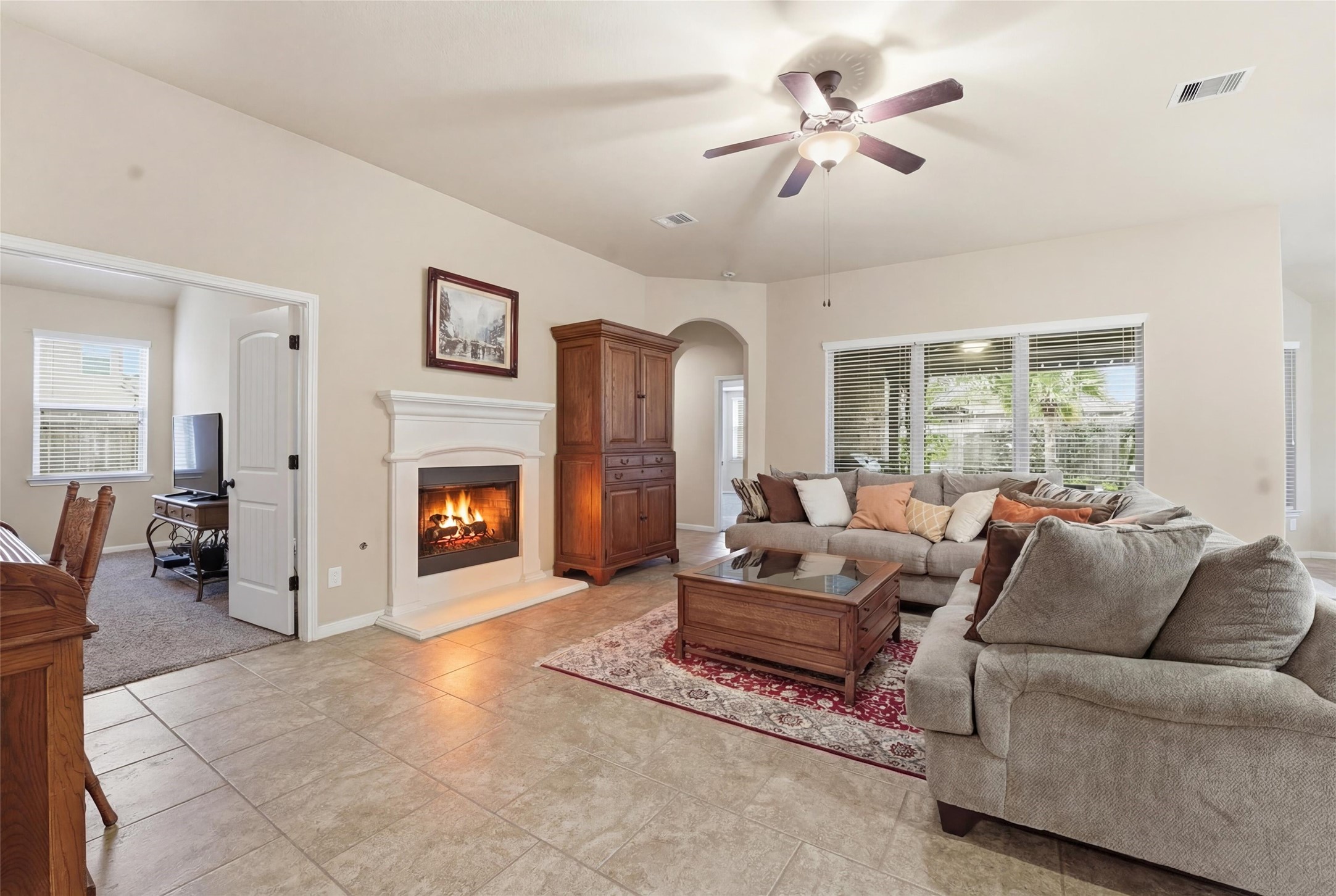 18115 Oliveria Way Houston, TX 77044 - Photo 13 of 32 a living room with furniture a large window and a fireplace