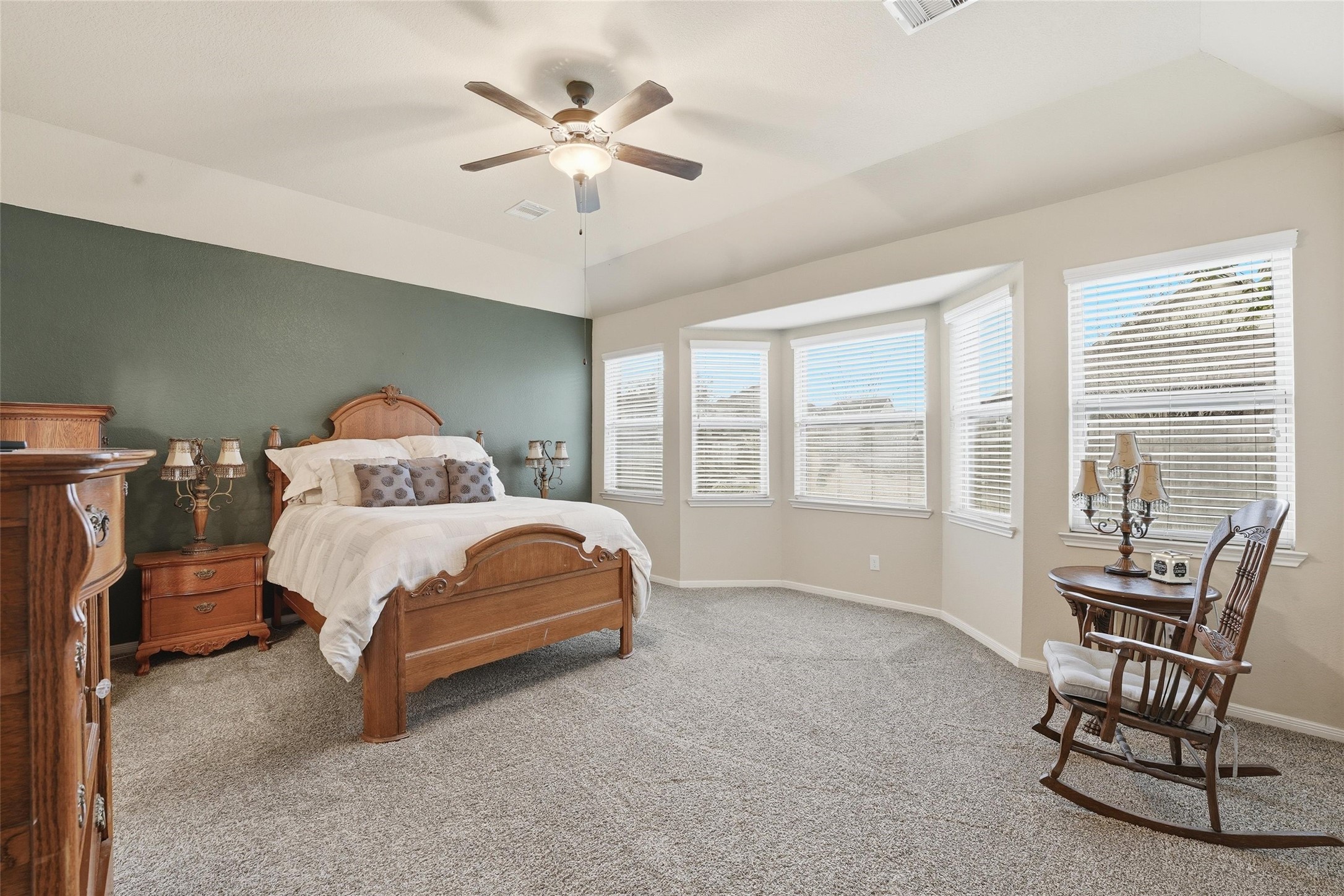 18115 Oliveria Way Houston, TX 77044 - Photo 15 of 32 a bedroom with a bed a chair and a large window
