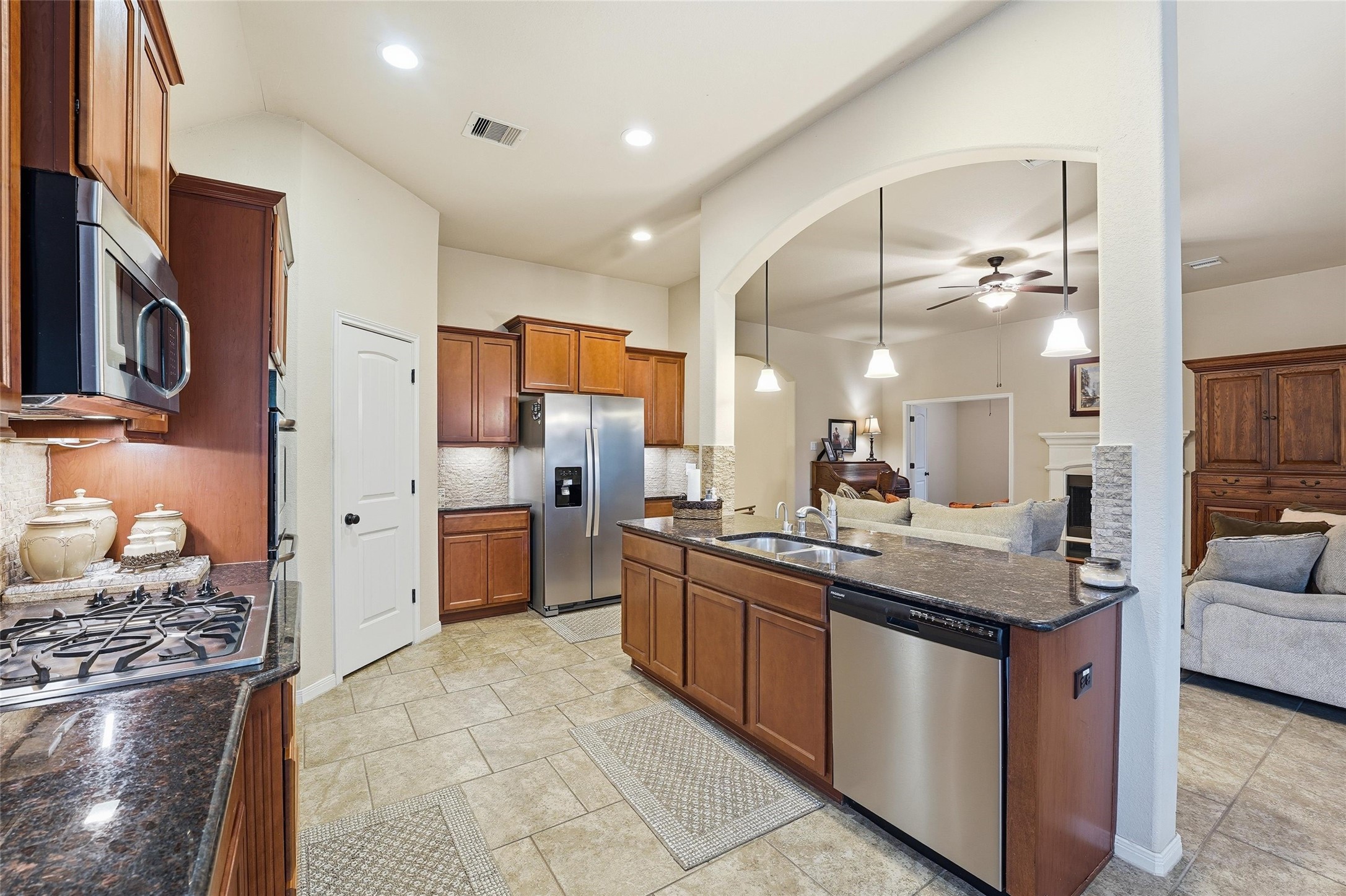 18115 Oliveria Way Houston, TX 77044 - Photo 6 of 32 a kitchen with stainless steel appliances granite countertop a sink and cabinets