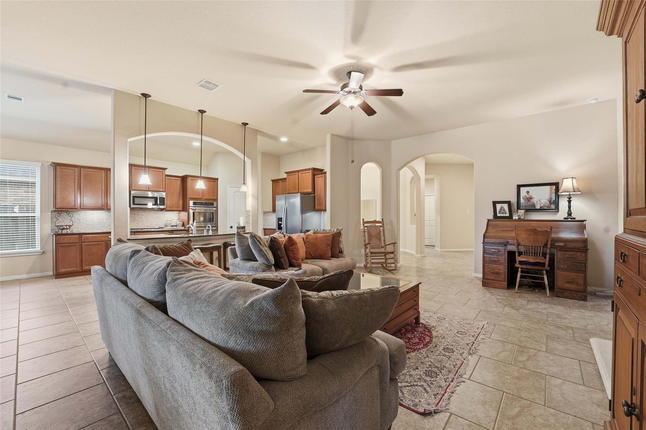 18115 Oliveria Way Houston, TX 77044 - Photo 10 of 32 a living room with furniture and a chandelier