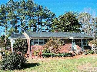 10840 Durham Road Timberlake, NC 27583 - Photo 1 of 1 front view of house with a small yard