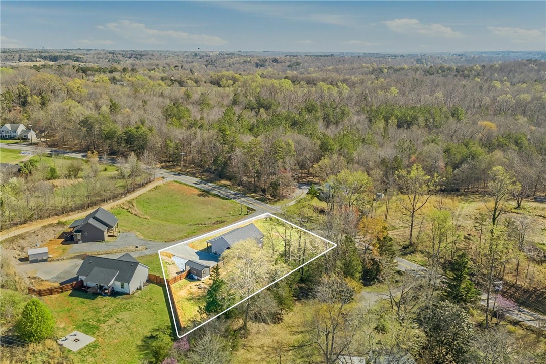 745 Dave Nix Road Seneca, SC 29678 - Photo 21 of 23 An aerial perspective showcases a private yard surrounded by a lush, wooded landscape.