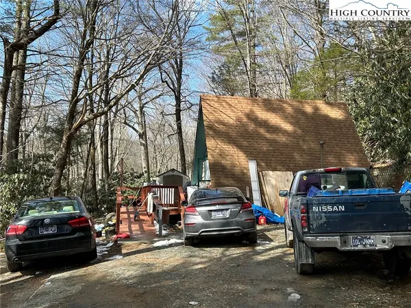 a view of a car park in front of a house