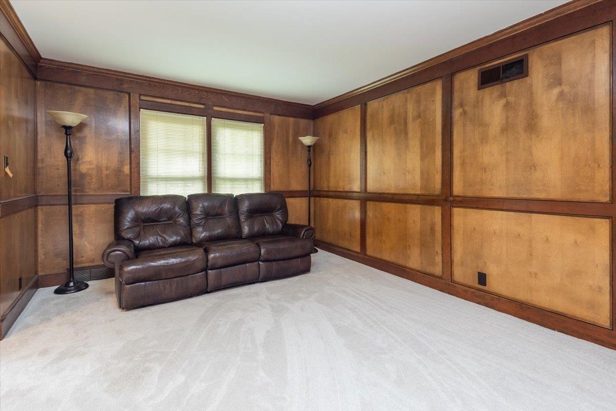 670 Peterson Lake Road Collierville, TN 38017 - Photo 11 of 37 Room with paneled wood-finish walls, crown molding, and light-colored carpeting