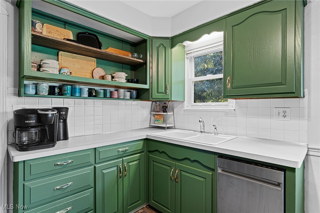 35221 Chestnut Ridge Road North Ridgeville, OH 44039 - Photo 24 of 48 Kitchen featuring green cabinetry, light countertops, dishwasher, open shelves, and decorative backsplash