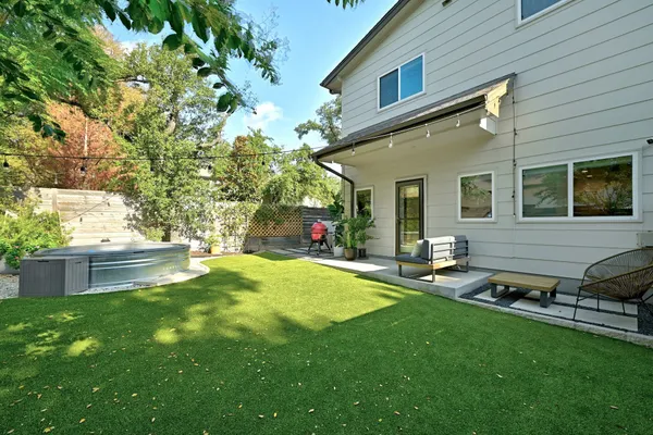a house view with a sitting space and garden