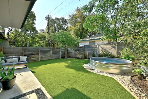a view of an house with backyard space and backyard