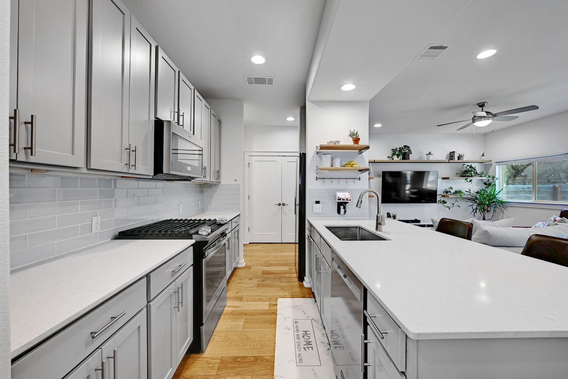 6800 Menchaca Road, Unit 24 Austin, TX 78745 - Photo 7 of 22 a large kitchen with stainless steel appliances kitchen island granite countertop a sink and cabinets