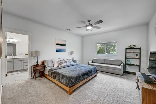 a bedroom with a bed couch and a window