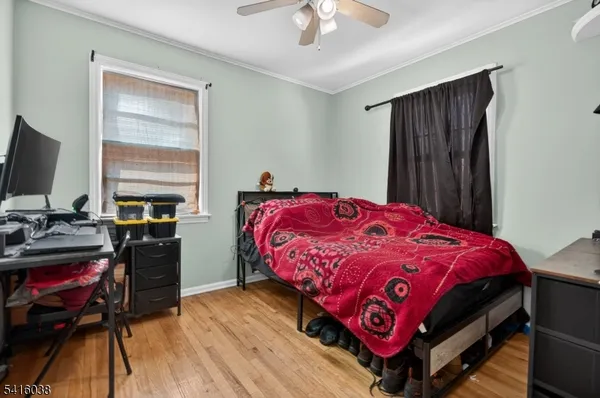 a bedroom with a bed and a flat tv screen on the dresser