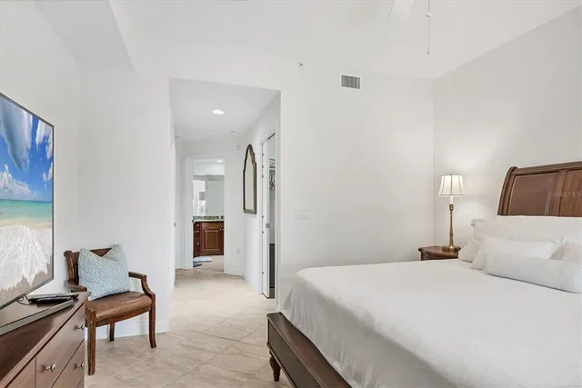 a bedroom with a bed and chair