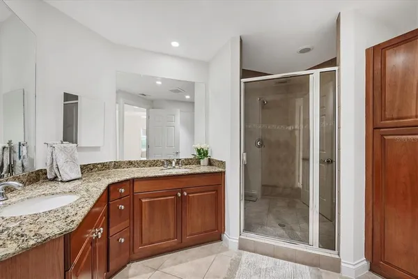 a bathroom with a granite countertop sink mirror and double