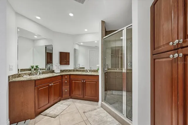 a large bathroom with a glass door shower and sink