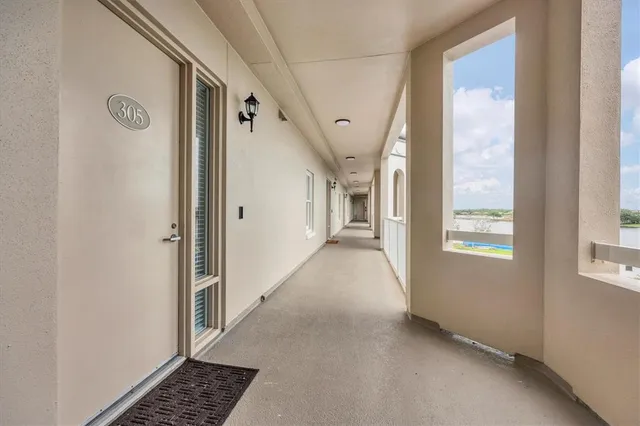 a view of hallway with windows and stairs