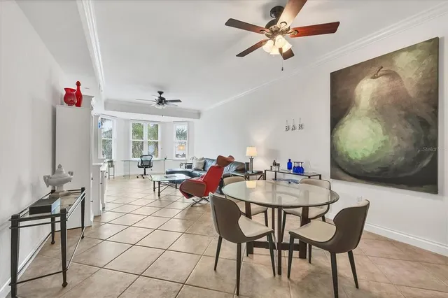 a view of a dining room with furniture and a chandelier fan