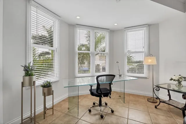 a view of a livingroom with workspace and a window