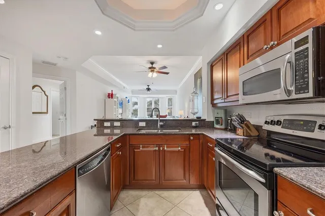 a kitchen with stainless steel appliances granite countertop a sink stove and microwave