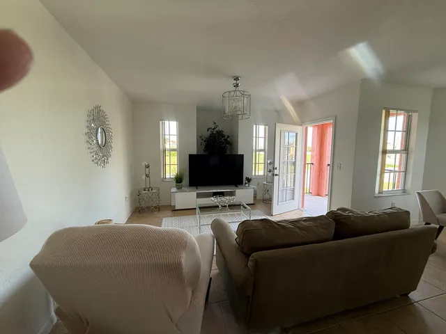 a green field with trees in the background