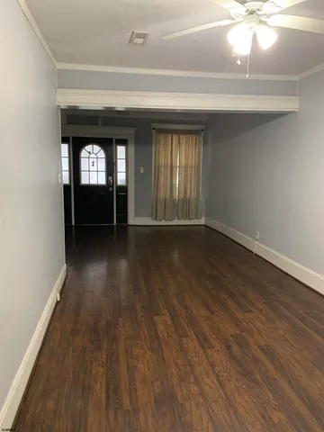 wooden floor in a hall with a window