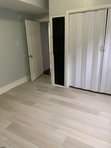 a view of a closet with wooden floor