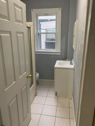 a bathroom with a sink toilet and window