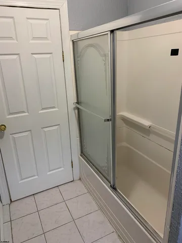 a bathroom with a glass door shower
