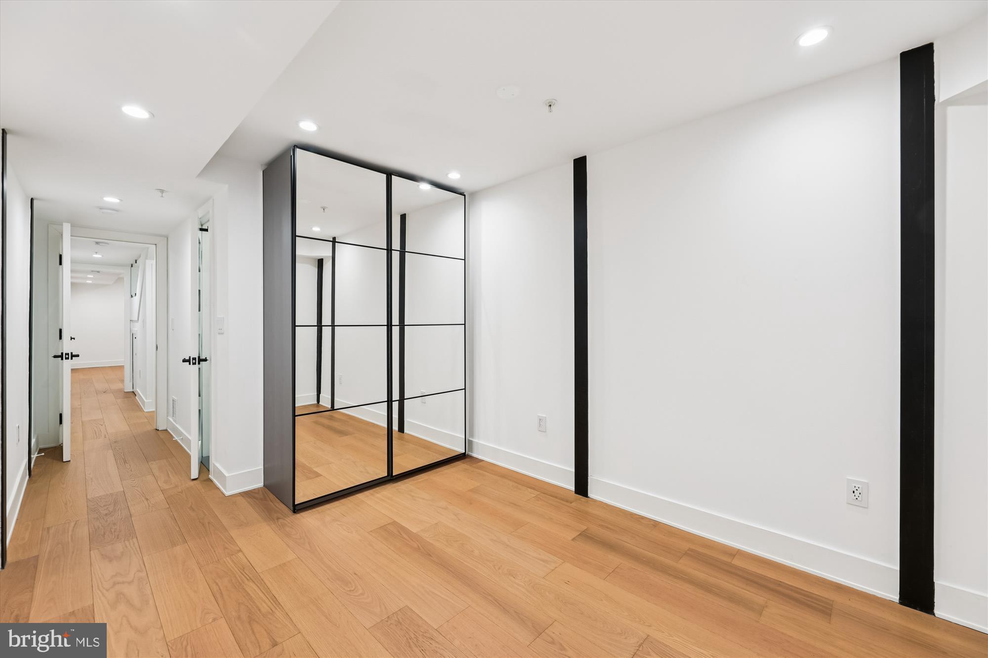 746 Morton Street Northwest, Unit 1 Washington, DC 20010 - Photo 27 of 35 an empty room with wooden floor and sliding door