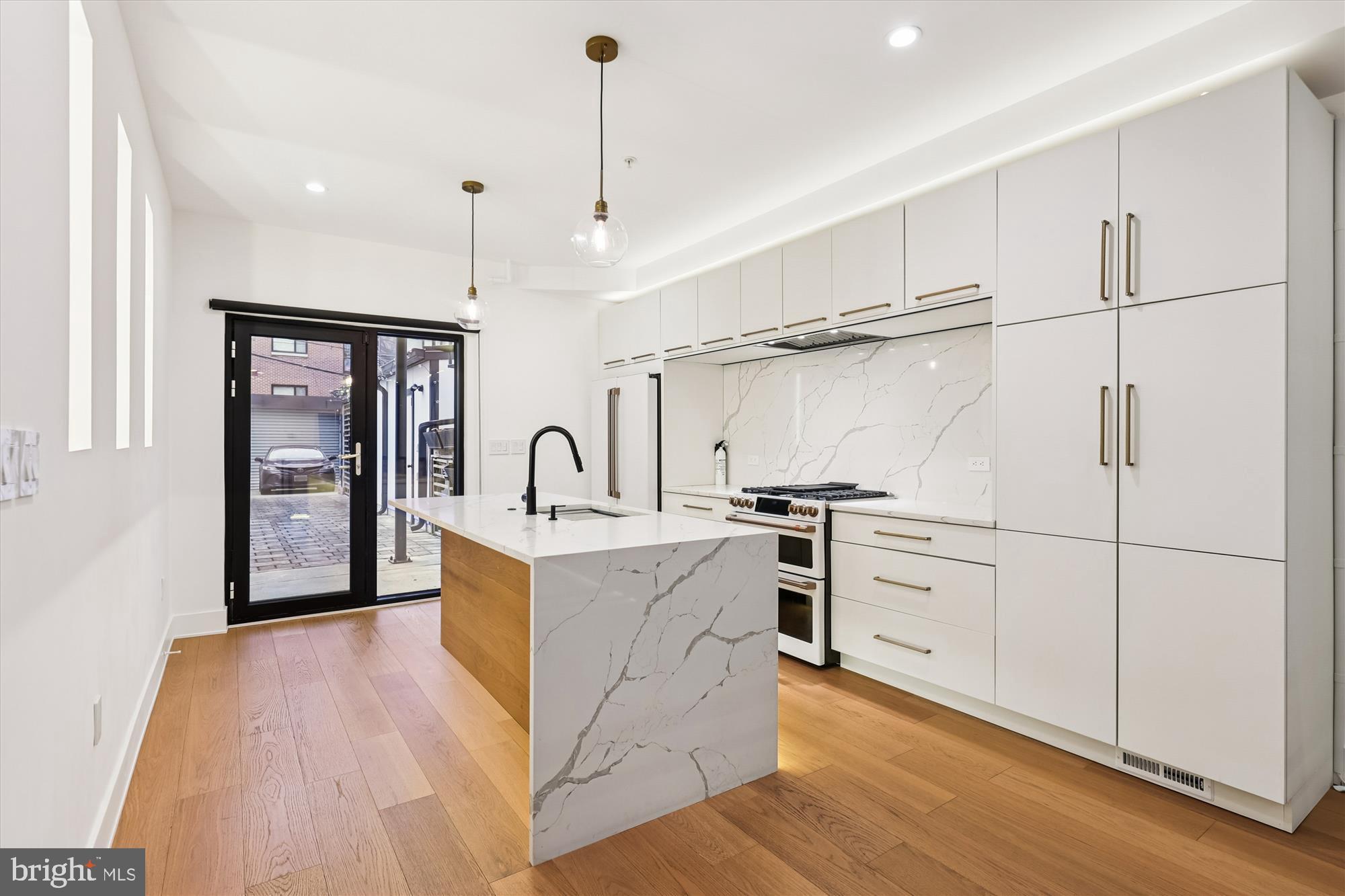 746 Morton Street Northwest, Unit 1 Washington, DC 20010 - Photo 6 of 35 a large kitchen with white cabinets and stainless steel appliances