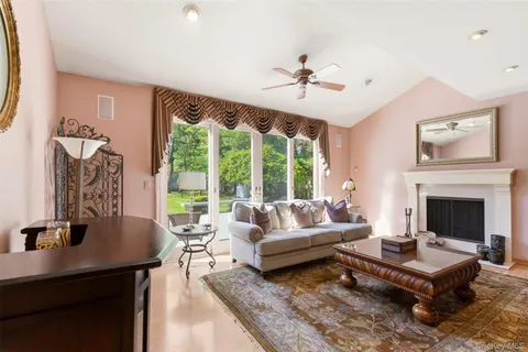 a living room with furniture a table and a large window