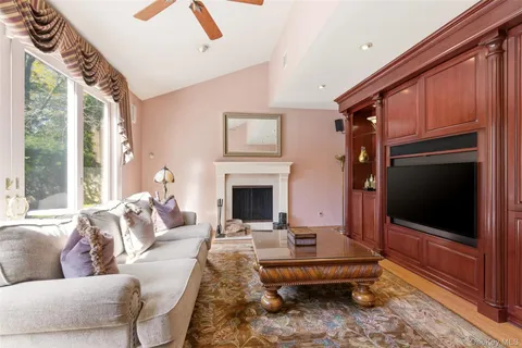 a living room with furniture fireplace and flat screen tv