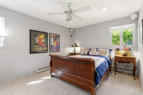 a bed room with a bed mirror and a window