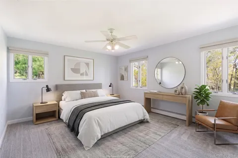 a bathroom with a double vanity sink window and a bathtub